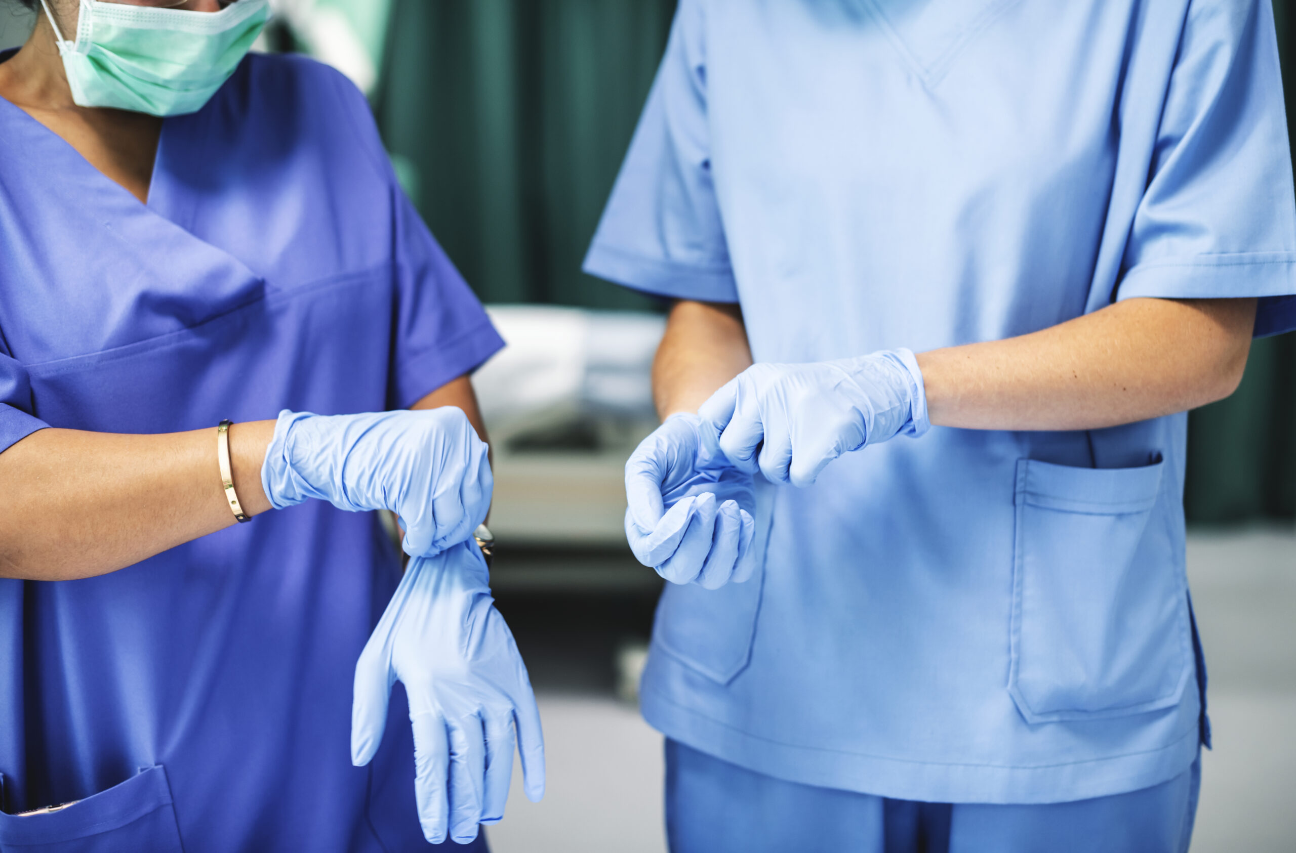 Surgeons wearing gloves preparing for surgery